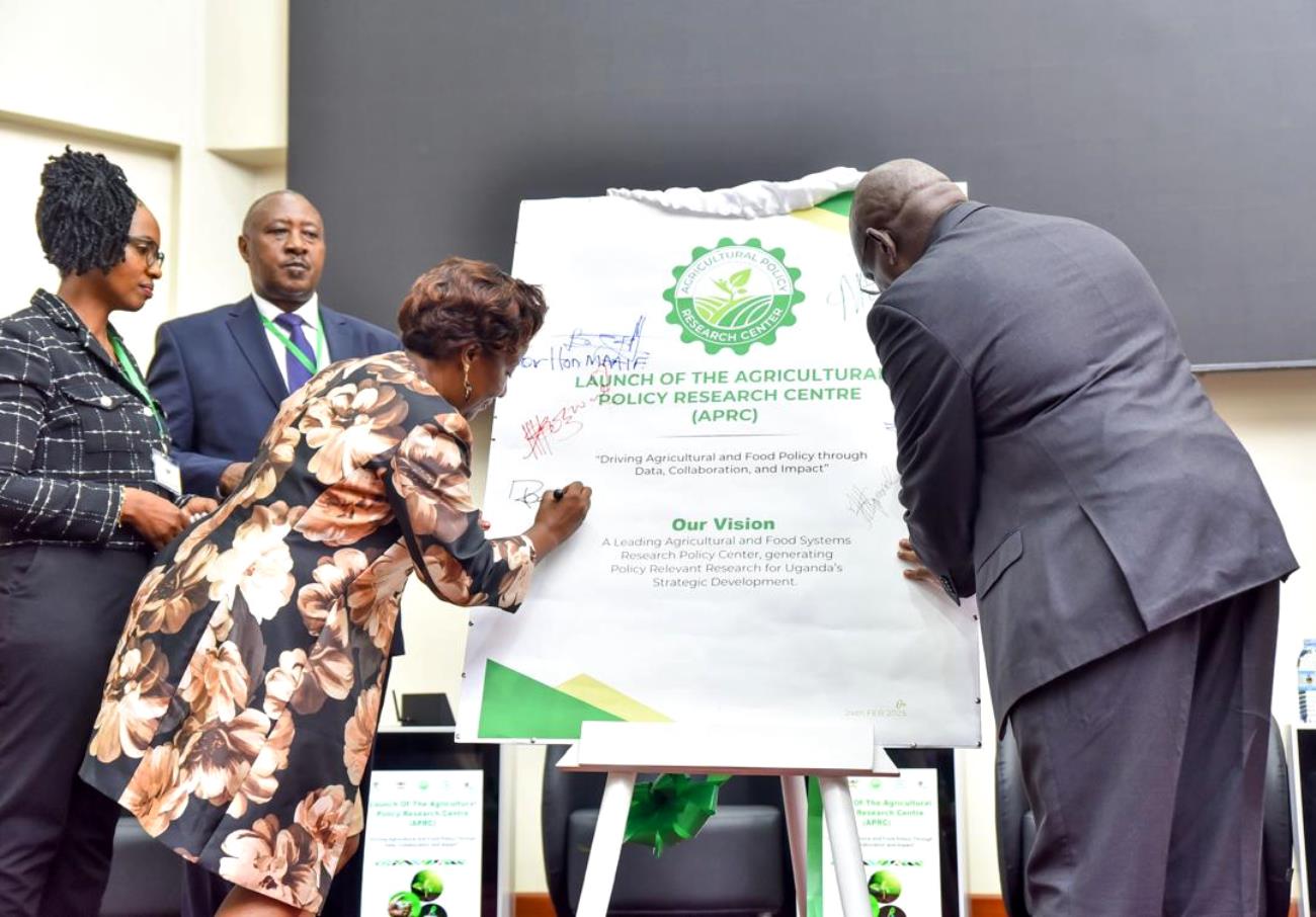 CAES Principal, Prof. Gorettie Nabanoga appending her signature in affirmation of the launch of the APRC. Official launch of Agricultural Policy Research Centre (APRC), College of Agricultural and Environmental Sciences (CAES) by Uganda’s Minister of Agriculture, Animal Industry, and Fisheries (MAAIF), represented by Mr. Steven Byantwale, the Commissioner for Crop Protection, 24th February 2025, Makerere University School of Public Health Auditorium, Kampala Uganda, East Africa.