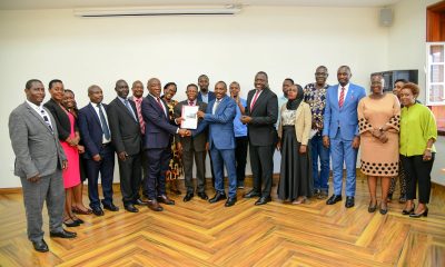 Prof. Buyinza Mukadasi (C), Members of Management and Staff witness as Prof. Henry Alinaitwe presents a copy of his handover report to Prof. Winston Tumps Ireeta. Prof. Henry Alinaitwe officially hands over Office of Deputy Vice Chancellor (Finance and Administration)-DVCFA to Prof. Winston Tumps Ireeta, 20th February 2025, Main Building, Makerere University, Kampala Uganda, East Africa.