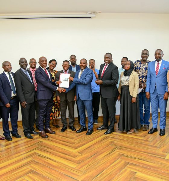 Prof. Buyinza Mukadasi (C), Members of Management and Staff witness as Prof. Henry Alinaitwe presents a copy of his handover report to Prof. Winston Tumps Ireeta. Prof. Henry Alinaitwe officially hands over Office of Deputy Vice Chancellor (Finance and Administration)-DVCFA to Prof. Winston Tumps Ireeta, 20th February 2025, Main Building, Makerere University, Kampala Uganda, East Africa.