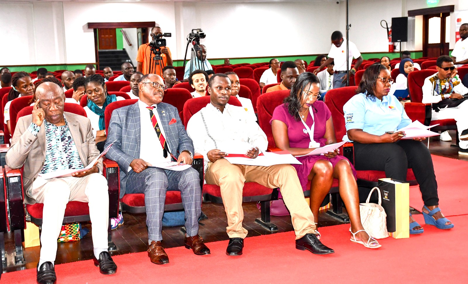 Prof. Nawangwe, flanked by Prof. Henry Alinaitwe, Prof. Justine Namaalwa, and officials from Mastercard Foundation listening attentively to presentations by young people. Makerere University hosts the Mastercard Foundation Scholars Council Representatives meeting, which brings together young people from around 45 partner universities of the Mastercard Foundation, 2nd February 2025, Kampala Uganda, East Africa.