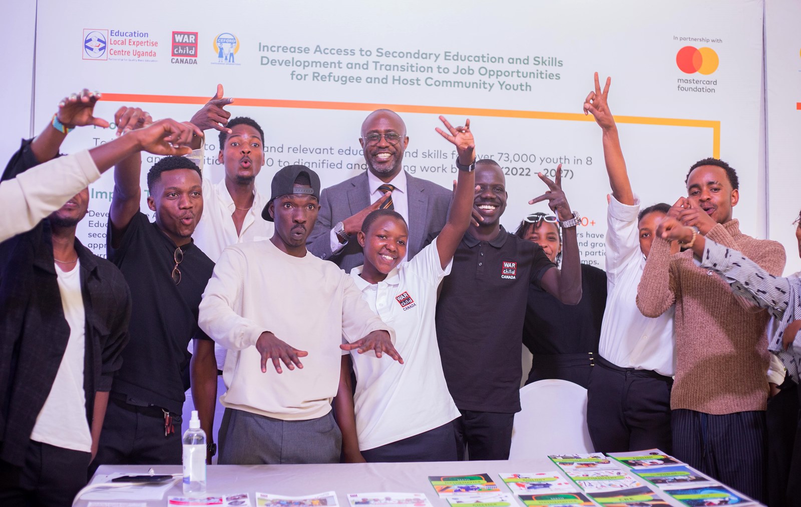 Mr. Adrian Bukenya, the Country Director, Mastercard Foundation-Uganda enjoys a photo moment with young people who attended the event. Young Africa Works Dialogue 2025 event at the Kampala Serena Hotel, participation by Mastercard Foundation Scholars Program at Makerere University, Kampala Uganda, East Africa.