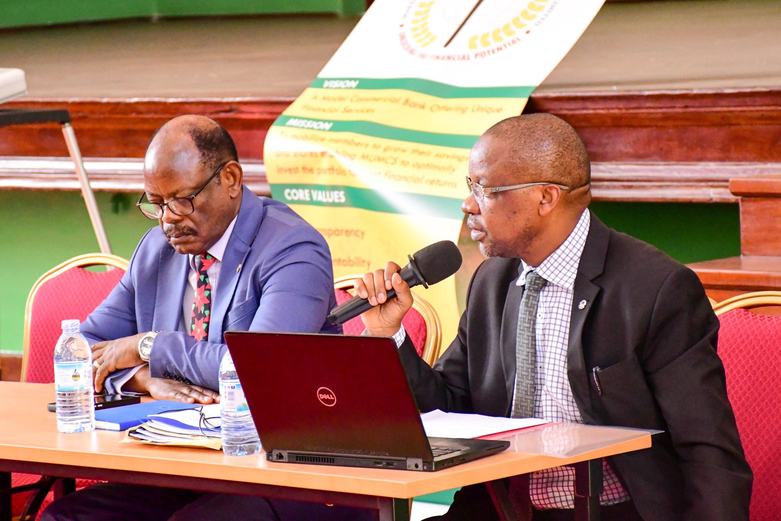 Prof. Juma Kasozi (Right) alongside Prof. Barnabas Nawangwe (Left) presents the Society's performance. Makerere University Multi-Purpose Co-operative Society (MUMCS) Annual General Meeting (AGM) to discuss the Society’s financial performance, progress and future plans, 26th February 2025, Main Hall, Kampala Uganda, East Africa.