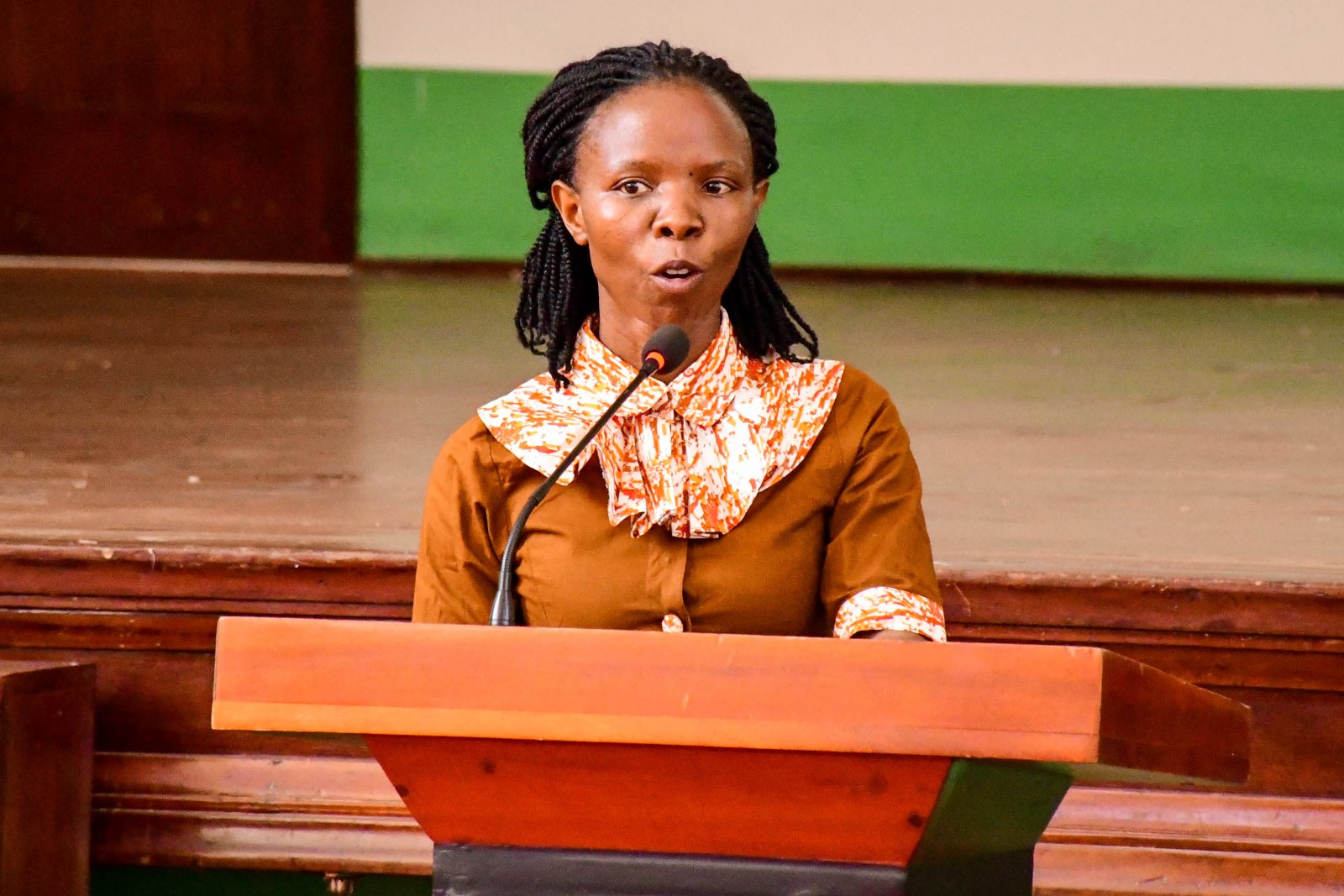 Ms Ritah Namisango speaks on behalf of the Welfare Committee. Makerere University Multi-Purpose Co-operative Society (MUMCS) Annual General Meeting (AGM) to discuss the Society’s financial performance, progress and future plans, 26th February 2025, Main Hall, Kampala Uganda, East Africa.