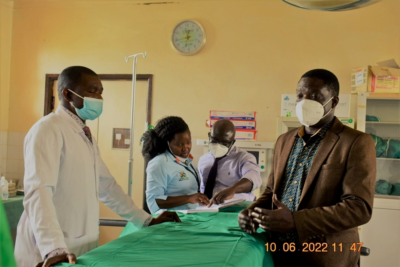 Dr. Ssenyondo Gonzaga (R), a consultant obstetrician/gynaecologist with Masaka Regional Referral Hospital talking with Dr. Mohammed Kawuki (L), the in-charge of Ntuusi Health Centre, while Dr. Eleanor Nakintu (2nd L) and Dr. Herbert Muyinda of CHDC looks at the theatre registry. Team from the Ministry of Health, and Makerere University, Kampala visit Ntuusi Health Centre IV in Sembabule district, Uganda, East Africa to follow-up on a mentorship training that was done a month earlier by Makerere University under the RMNCAH (Reproductive, Maternal, Neonatal, Child and Adolescent Health) Project.