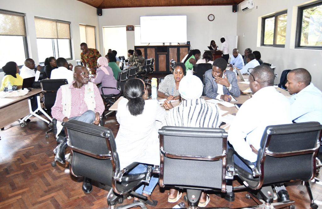 Dr. Paul Mukwaya (Left) with participants in a group discussion. Department of Geography, Geo-informatics, and Climatic Sciences, Makerere University in collaboration with University of Waterloo and University of Manchester, launch of project titled: The Urban Future Project: Toward Health Equity, Inclusive Governance and Climate Adaptation in African Informal Settlements, and Urban Heat Risk Awareness Raising and Knowledge Exchange and Urban Heat Management Handbook, 6th March 2025, Kampala Uganda, East Africa.