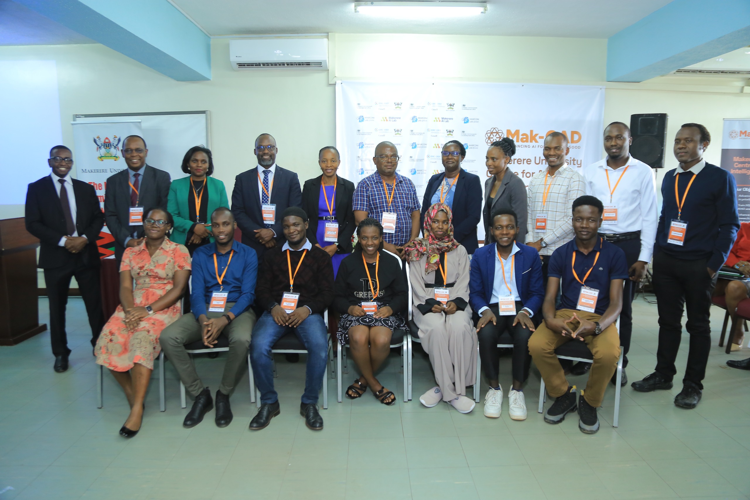 Scholarship recipients (seated) and project staff and supervisors in a group photo after the award. Official launch of the Makerere University Centre for Artificial Intelligence and Data Science (Mak-CAD), a hub dedicated to advancing AI research and innovation for Africa’s development. Theme: “Building Responsible AI Research and Innovations for Impact,” 13th March 2025, College of Computing and Information Sciences (CoCIS), Block B, Kampala Uganda, East Africa.