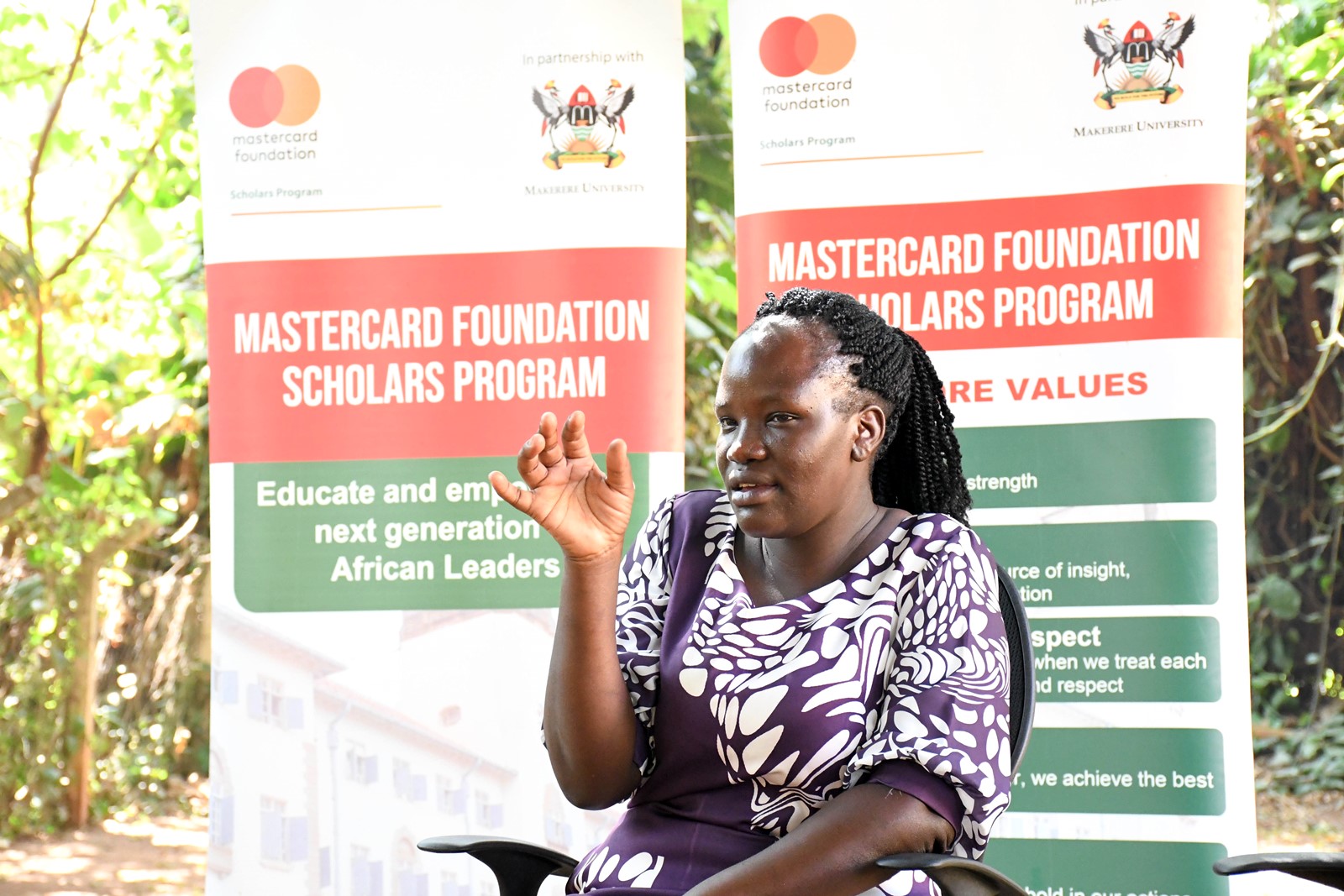 Winnie gestures during the interview. Mastercard Foundation Scholars Program at Makerere Univeristy alumna Winnie Kushaba, born in Rakai District, moved between Rakai, Ibanda, Kiruhura, Kazo, and Isingiro, searching for a place to call home, graduated with the Bachelor of Science degree in Botany and Chemistry in 2021, holds the dual roles of Product Development Manager and Internal Control Systems Manager at Bio Fresh Ltd, Kampala Uganda, East Africa.