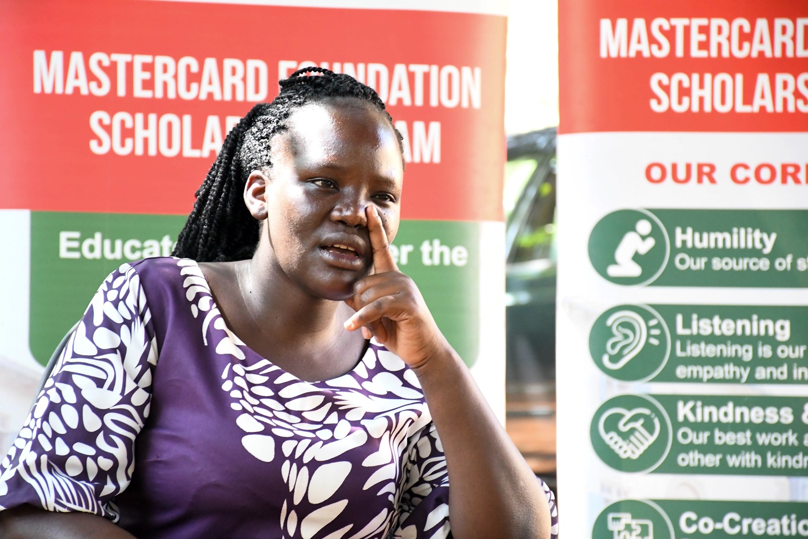 Winnie reflecting on her challenging childhood during the interview at Makerere University. Mastercard Foundation Scholars Program at Makerere Univeristy alumna Winnie Kushaba, born in Rakai District, moved between Rakai, Ibanda, Kiruhura, Kazo, and Isingiro, searching for a place to call home, graduated with the Bachelor of Science degree in Botany and Chemistry in 2021, holds the dual roles of Product Development Manager and Internal Control Systems Manager at Bio Fresh Ltd, Kampala Uganda, East Africa.