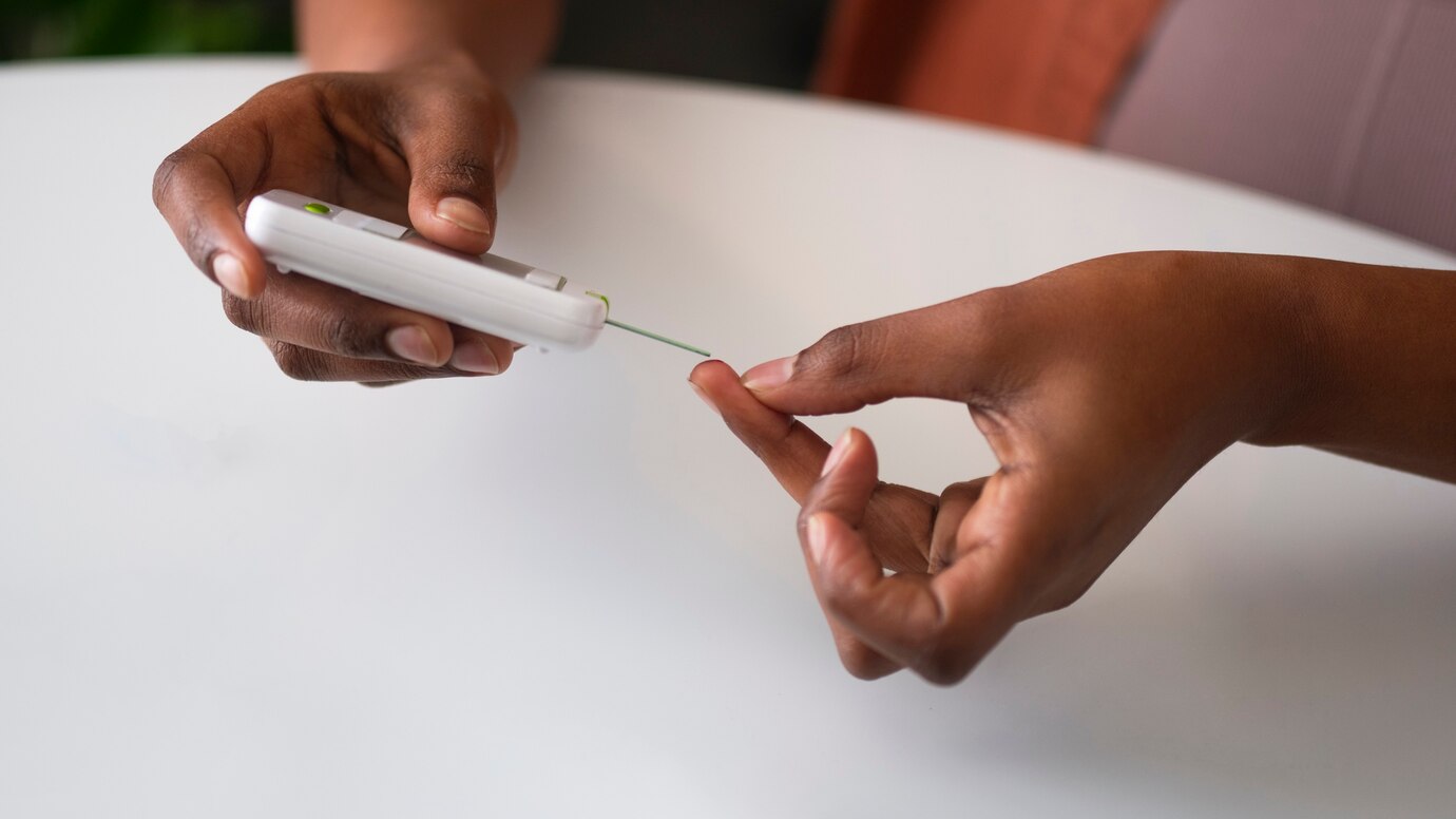 High angle woman checking glucose levels. Photo courtesy of Freepik. Makerere University School of Public Health (MakSPH), Kampala Uganda, East Africa.