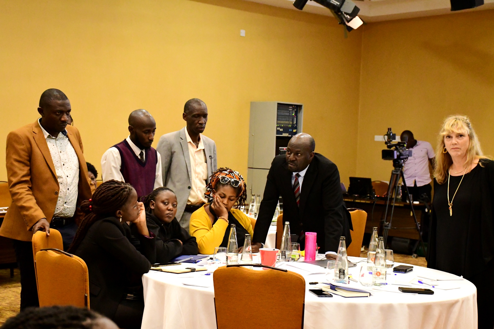 Prof Anthony Muwagga Mugagga (3rd Left) and Prof. Paul Birevu Muyinda (Leaning on table) with participants engaged in group assignments. Institute of Open, Distance and e-Learning (IODeL), College of Education and External Studies (CEES) disseminating results of phase 1 of the e-Learning initiative at Makerere University, Makerere University, Kampala Uganda, East Africa supported by Mastercard Foundation, Arizona State University (ASU)-USA, to over 75 participants and key stakeholders, 24th April 2025, Speke Resort Munyonyo.