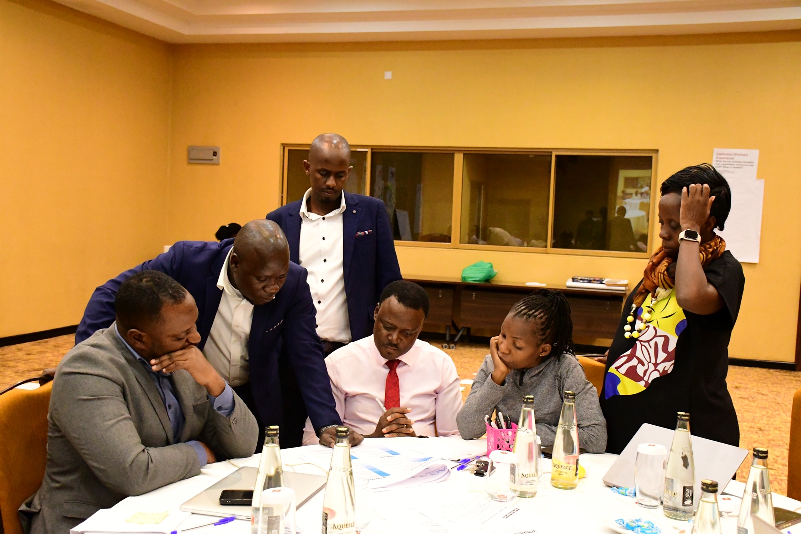 Another group of participants engaged in group assignments. Institute of Open, Distance and e-Learning (IODeL), College of Education and External Studies (CEES) disseminating results of phase 1 of the e-Learning initiative at Makerere University, Makerere University, Kampala Uganda, East Africa supported by Mastercard Foundation, Arizona State University (ASU)-USA, to over 75 participants and key stakeholders, 24th April 2025, Speke Resort Munyonyo.