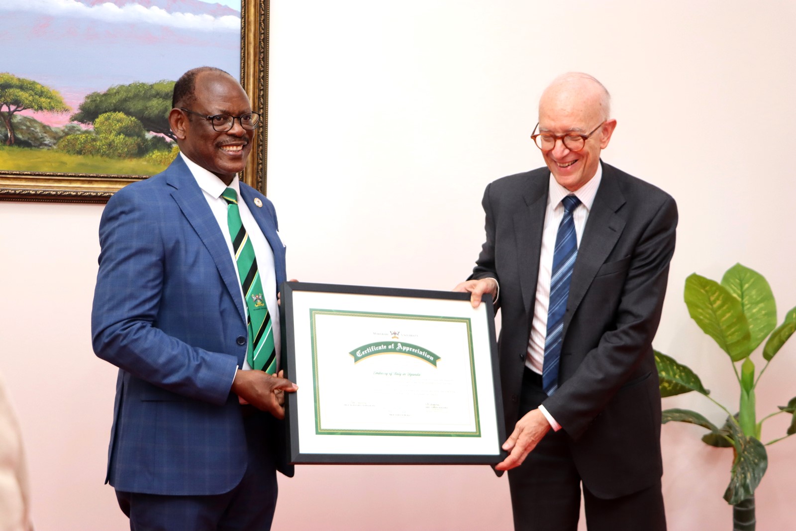 Prof. Nawangwe hands over a Certificate of Appreciation to the Ambassador for the 100 years of collaboration. Makerere University, in collaboration with the University of Turin and the Italian Embassy in Kampala, marked four decades of academic and cultural partnership with a landmark photographic exhibition titled "Connecting Cultures: The Italian Ethnological Mission in the Great Lakes Region" 16th May 2025, Arts Quadrangle, College of Humanities and Social Sciences (CHUSS), Uganda, East Africa.