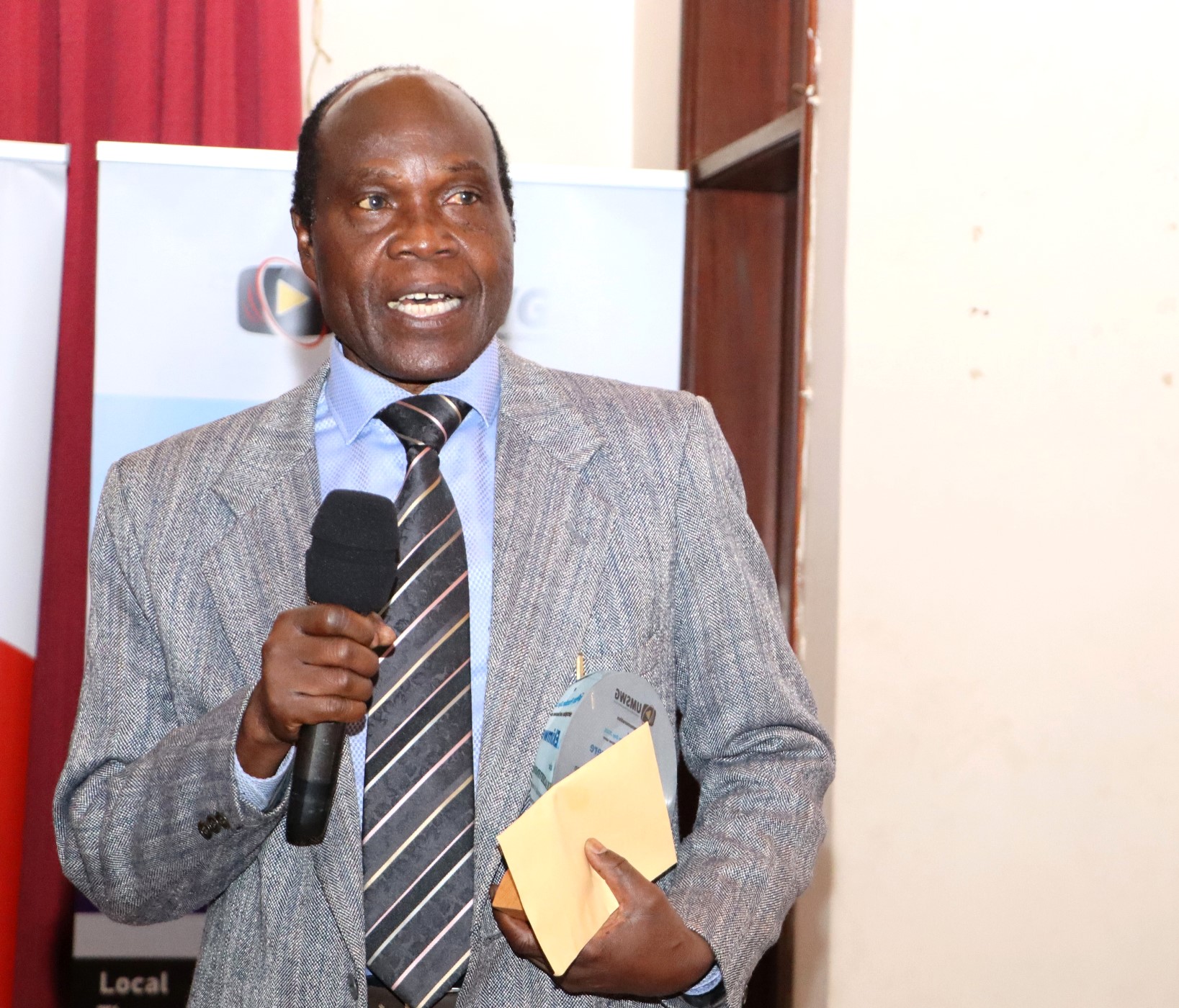 Dr. Zadok Ekimwere giving remarks after the recognition award. Uganda Media Sector Working Group in collaboration with Makerere University Department of Journalism and Communication, CIPESA, Oslo Metropolitan University, the Uganda Human Rights Commission, the African Centre for Media Excellence, UNESCO, the Uganda Media Council, and Media Focus on Africa commemorating World Press Freedom Day, global theme “Defending the Truth in an Age of Polarization and Distrust”, 6th May 2025, CEDAT Conference Hall, Kampala, East Africa.