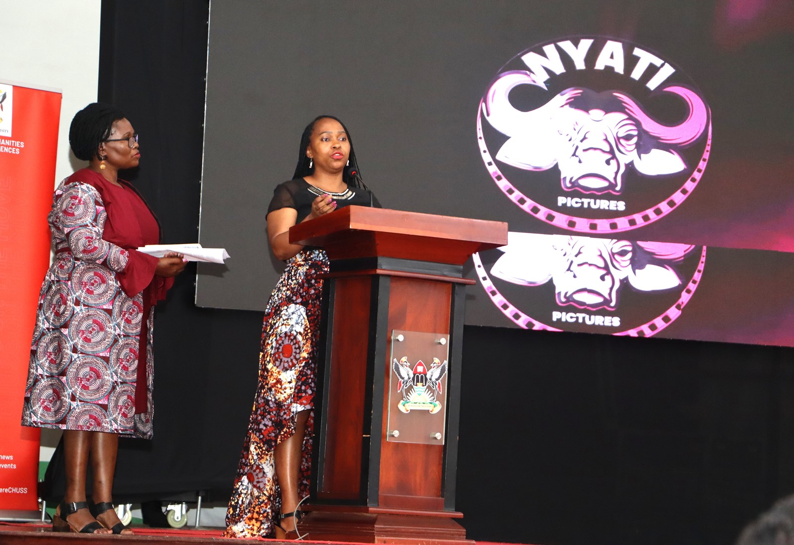 Dr. Cindy Magara flanked by Head of Department of Literature, Dr. Eve Nabulya addressing the audience. Department of Literature, School of Languages, Literature and Communication, College of Humanities and Social Sciences (CHUSS) screening of Tuko Pamoja, a documentary by Dr. Cindy Magara, Nyati Motion Pictures, 13th May 2025, Main Hall, Makerere University, Kamapala Uganda, East Africa.