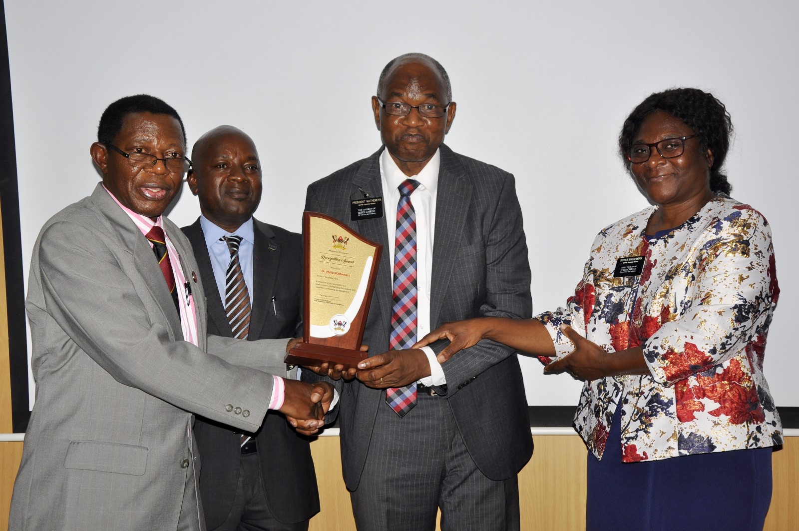 Brother Mathemera receiving a plaque. Church of Jesus Christ of Latter-day Saints handed over 40 high-tech laptops and 10 projectors to Makerere University to facilitate teaching, learning, and research at the School of Business under the College of Business and Management Sciences (CoBAMS), 5th May 2025, Kampala Uganda, East Africa.
