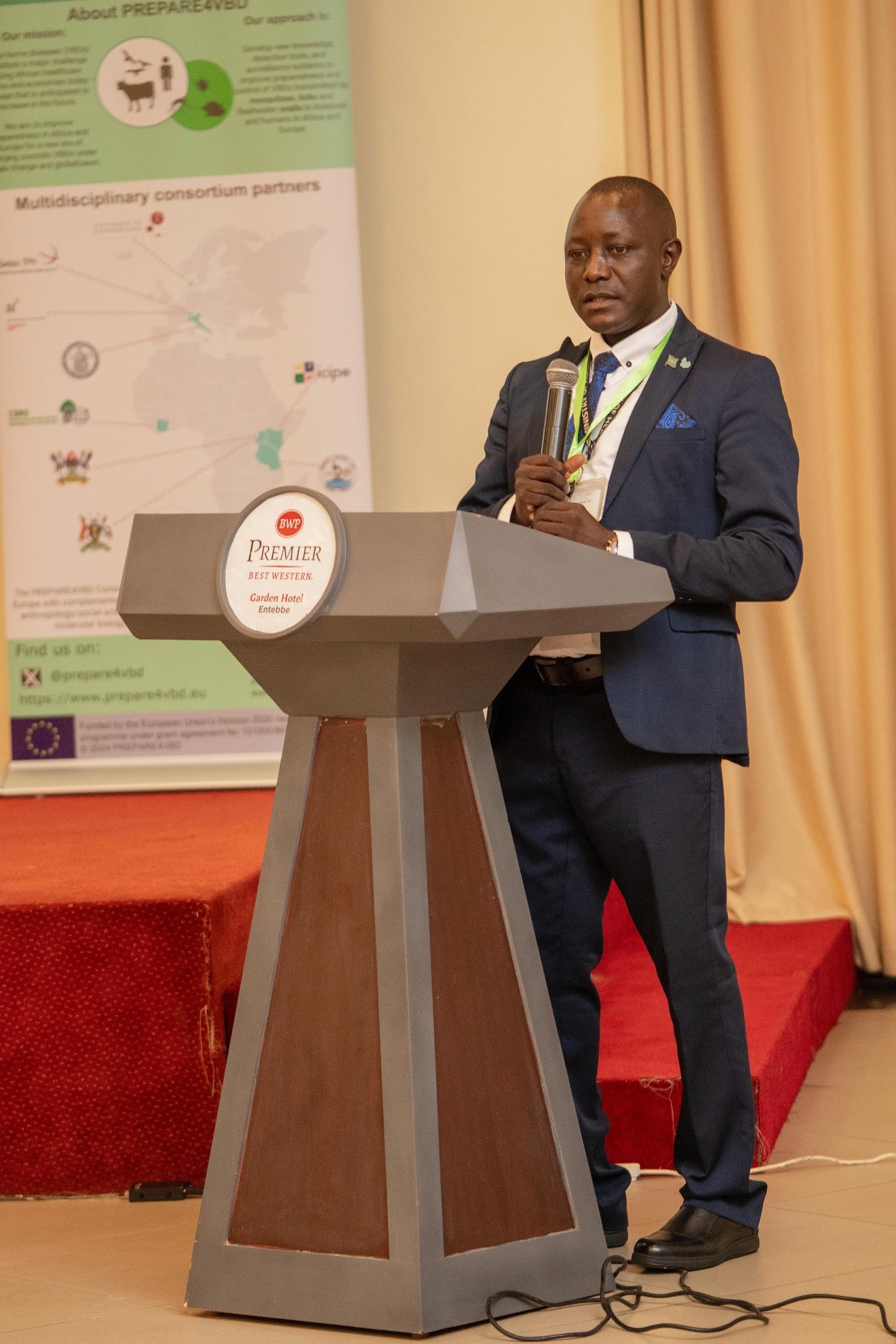 Adriko Moses from the Ministry of Health sharing about importance of a multi-stakeholder approach to mitigate risks of liver fluke infections. Final dissemination workshop of the EU-funded project: A Cross-Disciplinary Alliance to Identify, PREdict, and PrePARe for Emerging Vector-Borne Diseases (PREPARE4VBDs) with Prof. Lawrence Mugisha Co-Principal Investigator from College of Veterinary Medicine, Animal Resources and Biosecurity (CoVAB), Makerere University, held 5th-8th May 2025, Best Western Premier Garden Hotel, Entebbe, Uganda, East Africa.