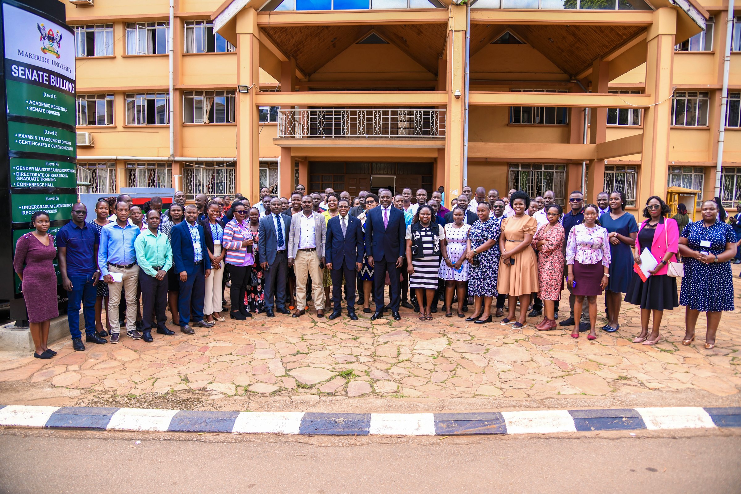 Prof. Buyinza Mukadasi, Mr. Deus Tayari Mujuni, Mr. Yusuf Kiranda and Mr. Amon Muteganda pose for a group photo with new staff during the induction ceremony on 15th May 2025. Makerere University on Thursday 15th May, 2025 embarked on a two-day induction exercise spearheaded by the Directorate of Human Resources for newly appointed staff, whose tenures commenced in the 2024/2025 financial year, Senate Conference Hall, Kampala Uganda, East Africa.