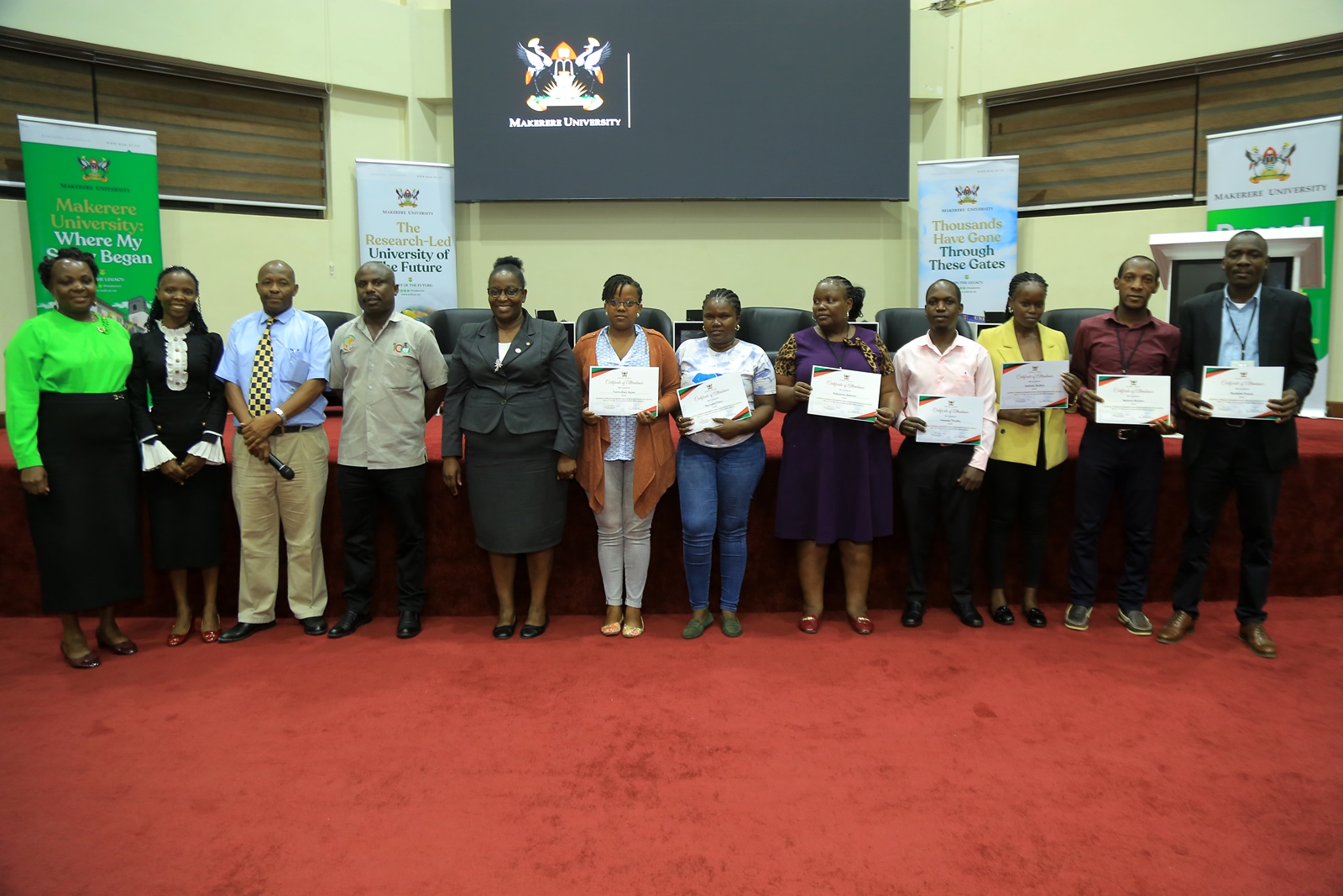 L-R: Ms. Josephine Nalweyiso, Ms. Ritah Namisango, Mr. Julius Lebo, Mr. Deus Tayari Mujuni and Prof. Helen Nkabala pose for a group photo with some of the newly appointed during the certificate award ceremony. Makerere University day two of induction exercise spearheaded by the Directorate of Human Resources for newly appointed staff, whose tenures commenced in the 2024/2025 financial year, 16th May 2025, School of Public Health (MakSPH) Auditorium, Kampala Uganda, East Africa.