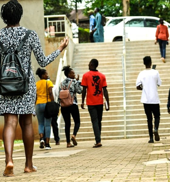 Students stroll past the Frank Kalimuzo Central Teaching Facility-CTF (Left) and School of Social Sciences (Right) on the Makerere University Main Campus. Staircase, Walkway, Male, Female, Kampala Uganda, East Africa.
