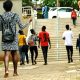 Students stroll past the Frank Kalimuzo Central Teaching Facility-CTF (Left) and School of Social Sciences (Right) on the Makerere University Main Campus. Staircase, Walkway, Male, Female, Kampala Uganda, East Africa.