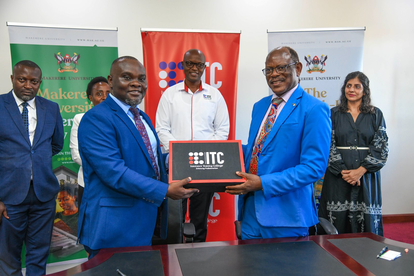 Prof. Barnabas Nawangwe and Mr. Saul Sseremba exchange souvenirs. Makerere University signs Memorandum of Understanding (MoU) with the Insurance Training College (ITC) to be implemented through the College of Business and Management Sciences (CoBAMS) aimed at enhancing professional training, research, and industry engagement in the fields of actuarial science and insurance, 6th May 2025, Main Building, Makerere University, Kampala Uganda, East Africa.