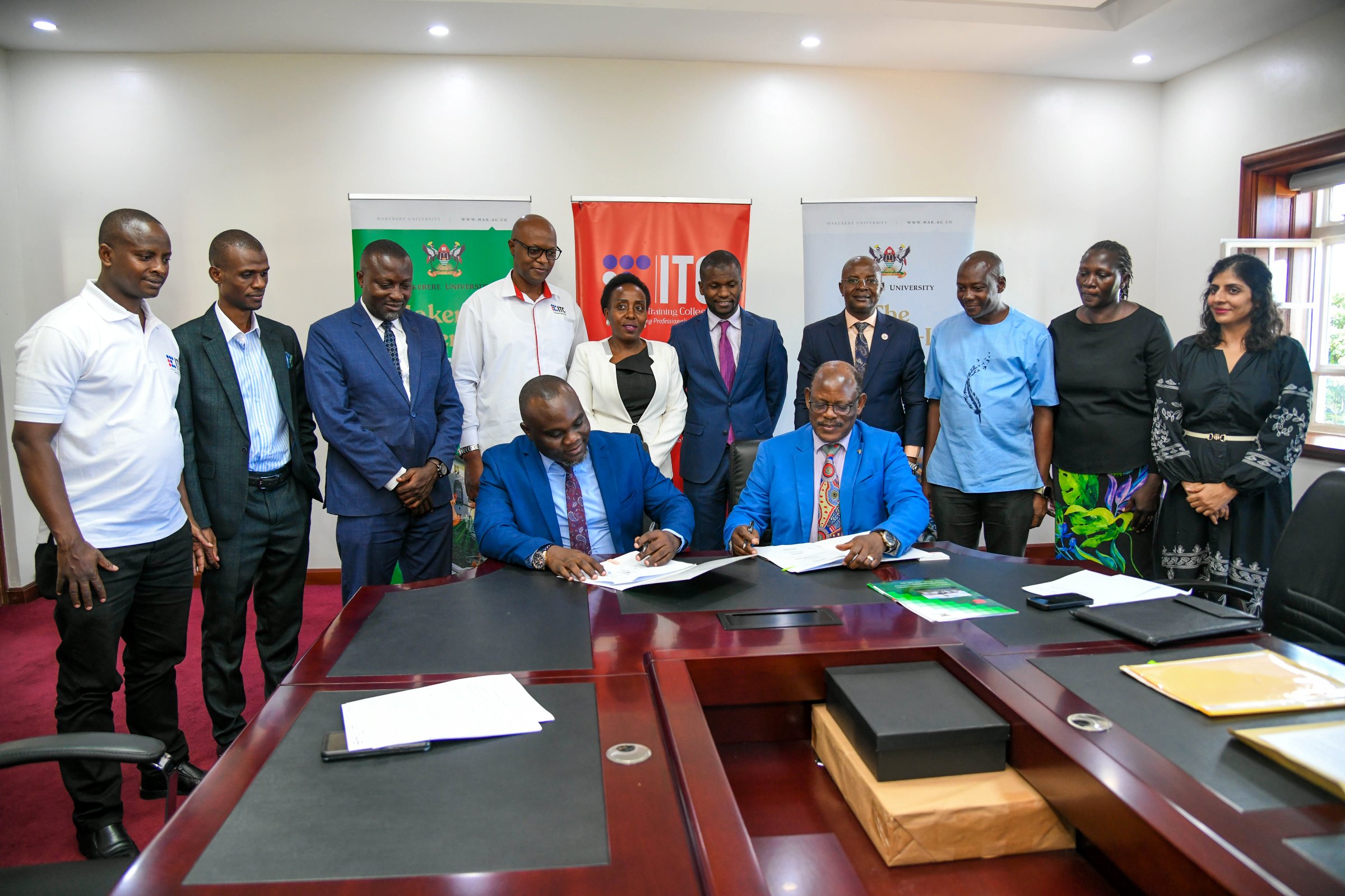 The Vice Chancellor, Prof. Barnabas Nawangwe (Seated Right) and the Insurance Training College (ITC) CEO, Mr. Saul Sseremba (Seated Left) sign the MoU as officials from Makerere and ITC witness on 6th May 2025. Makerere University signs Memorandum of Understanding (MoU) with the Insurance Training College (ITC) to be implemented through the College of Business and Management Sciences (CoBAMS) aimed at enhancing professional training, research, and industry engagement in the fields of actuarial science and insurance, 6th May 2025, Main Building, Makerere University, Kampala Uganda, East Africa.