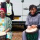 Mariatheresa David Mwamakula - granddaughter of Mwalimu Julius Nyerere (Right) and Ms Butiku Sangu (Left) drum during one of the interactive sessions of the Festival. Julius Nyerere Youth Festival 2025 held under the theme, "Our Heritage, Our Voices: Culture, Innovation, and Servant Leadership," 15th-16th April 2025, Yusuf Lule Central Teaching Facility Auditorium, Makerere University, Kampala Uganda, East Africa.