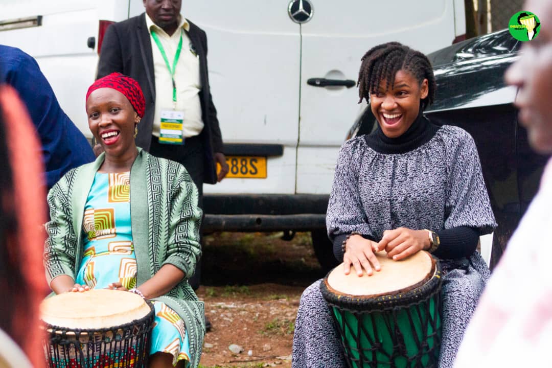 Mariatheresa David Mwamakula - granddaughter of Mwalimu Julius Nyerere (Right) and Ms Butiku Sangu (Left) drum during one of the interactive sessions of the Festival. Julius Nyerere Youth Festival 2025 held under the theme, "Our Heritage, Our Voices: Culture, Innovation, and Servant Leadership," 15th-16th April 2025, Yusuf Lule Central Teaching Facility Auditorium, Makerere University, Kampala Uganda, East Africa.