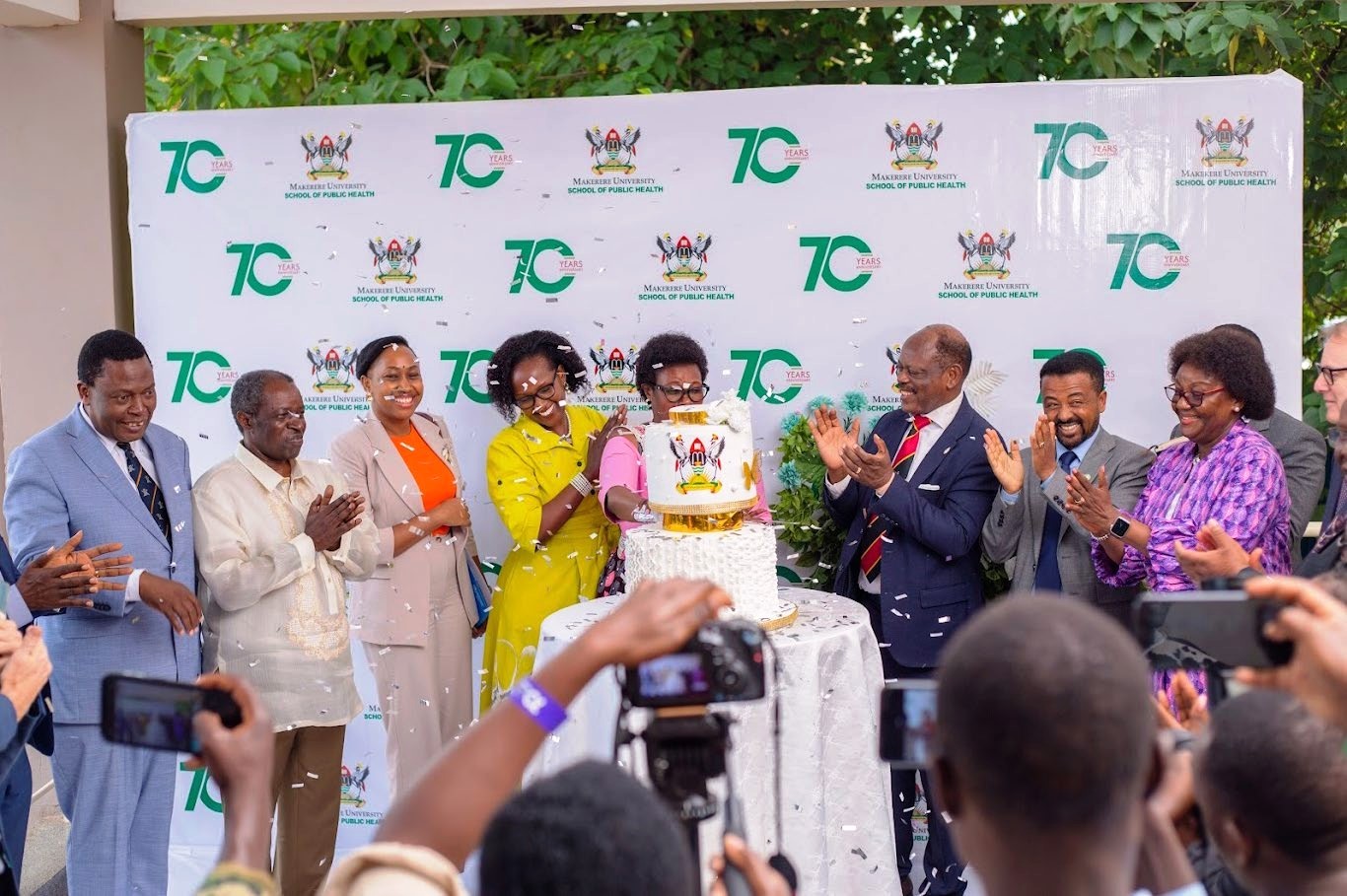 Partners from the Ministry of Health, WHO, and Makerere University leadership, including Council Chairperson Ms. Lorna Magara, Vice Chancellor Prof. Barnabas Nawangwe, and Dean Prof. Rhoda Wanyenze, join the Minister of Health in cutting the MakSPH@70 anniversary cake. 13th December 2024, MakSPH Auditorium, Makerere University, Kampala Uganda, East Africa.