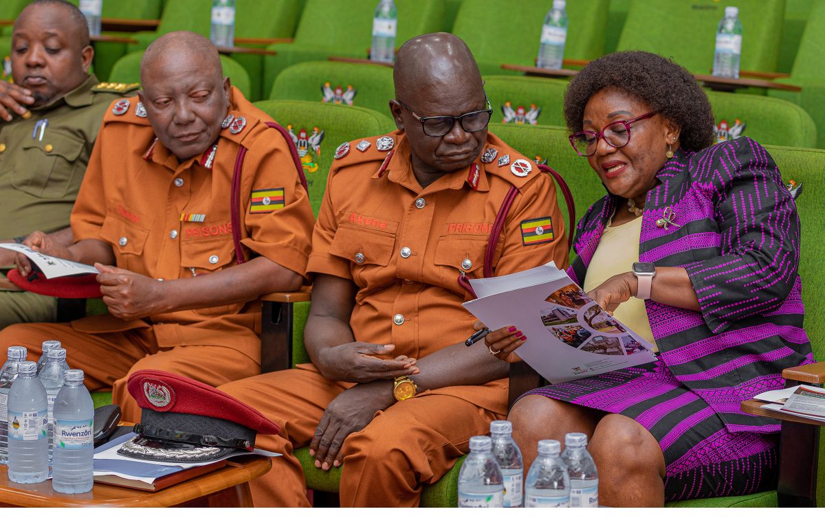Professor Rhoda Wanyenze compares notes with Mr. Samuel Akena during the event. Release of findings of Uganda National Prevalence Survey on Tuberculosis, HIV, and COVID-19 conducted by Makerere University School of Public Health (MakSPH) in conjunction with the Uganda Prisons Services (UPS) and the Ministry of Health—with funding from the U.S. President’s Emergency Plan for AIDS Relief (PEPFAR) and technical support from the U.S. Centers for Disease Control and prevention (CDC), 15th May 2025, MakSPH Auditorium, Makerere University, Kampala Uganda, East Africa.