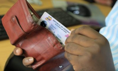 A man reaches for the Uganda National ID from his wallet. New study, “Understanding the Benefits, Costs, and Challenges of the National Identification System in Uganda,” published in Digital Society, for every US$1 invested in the NID system, the return on investment is US$1.35, led by Roy William Mayega from Makerere University School of Public Health’s Resilient Africa Network (MakSPH-RAN), Kampala, Uganda, East Africa.