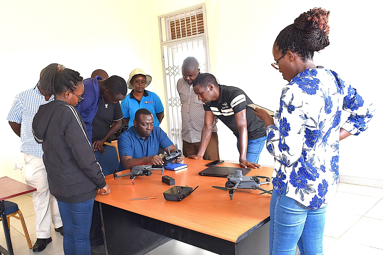 The project team receiving training on drone operations at Rwebitaba Tea Research Centre. Nature-based Solutions for Tea (NbS4Tea) project at College of Agricultural and Environmental Sciences (CAES), Makerere University, Kampala, Funded by the Danish Fellowship Centre under Denmark’s Ministry of Foreign Affairs, deployment of drones to improve environmental and agricultural data collection at Rwebitaba Tea Research Centre in Kyenjojo District, Uganda, East Africa, 19th June 2025.