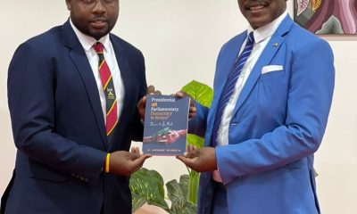 Prof. Barnabas Nawangwe receiving Prof. Anyang' Nyong'o's book from Mr. Katumba Salim