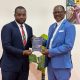 Prof. Barnabas Nawangwe receiving Prof. Anyang' Nyong'o's book from Mr. Katumba Salim