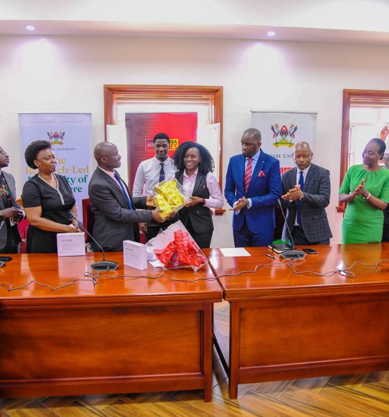 National Medical Director-AHF Uganda Cares, Dr. Lubanga Augustine hands over condom dispensers and condoms to the 91st Vice Guild President-H.E. Kadondi Gracious as officials witness on 30th July 2025. Makerere University and the Aids Healthcare Foundation (AHF) Uganda Cares meeting to collaborate on HIV/AIDS prevention and care services for the University’s student population, 30th July 2025, Main Building, Kampala Uganda, East Africa.