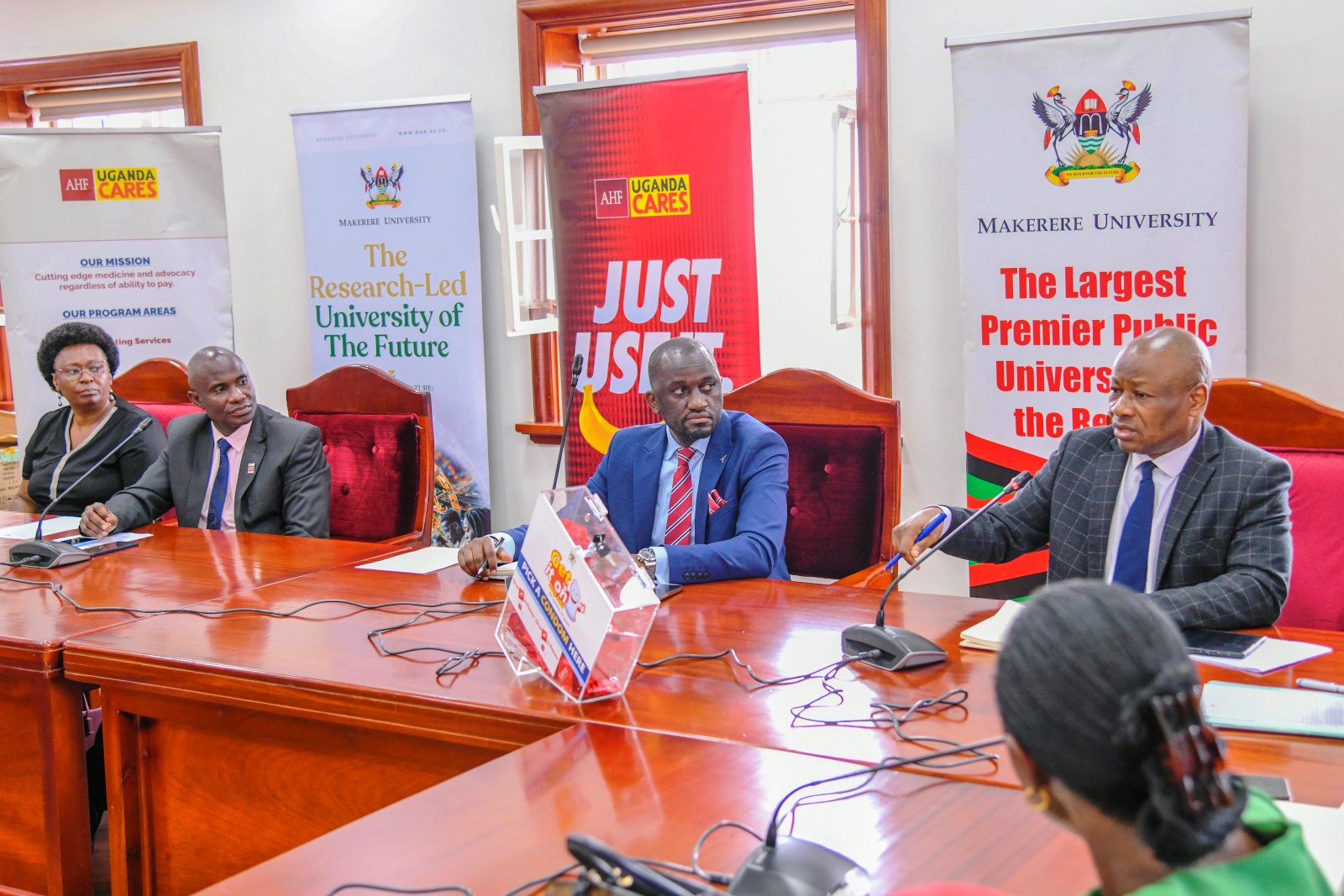 Prof. Josaphat Byamugisha (Right) makes his remarks as Dr. Lubanga Augustine (Left) and Mr. Simon Kizito (Centre) listen. Makerere University and the Aids Healthcare Foundation (AHF) Uganda Cares meeting to collaborate on HIV/AIDS prevention and care services for the University’s student population, 30th July 2025, Main Building, Kampala Uganda, East Africa.