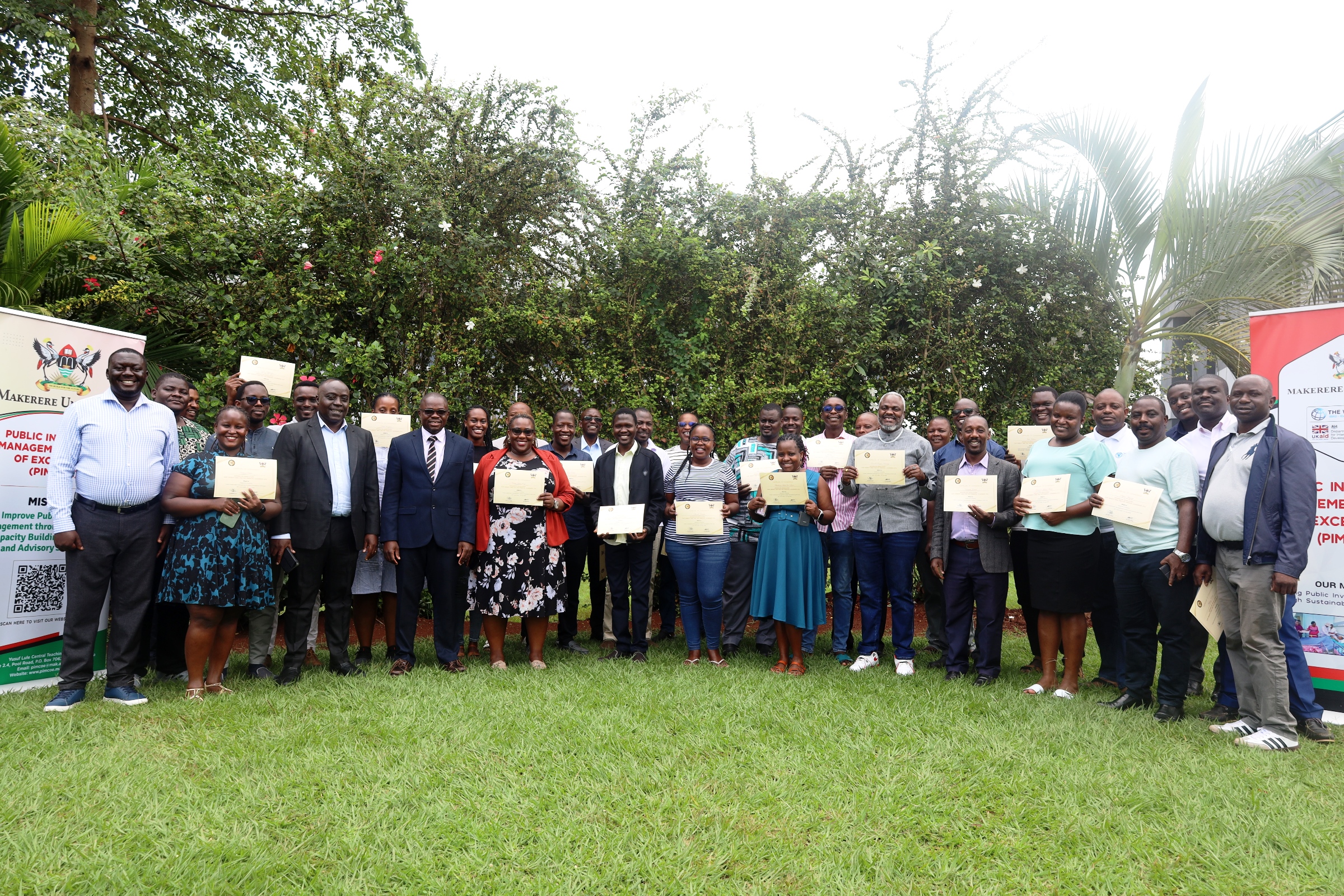 Commissioner Paul Mwanja and Assoc. Prof. Ibrahim Mike Okumu pose for a photo with participants after the certificate award ceremony on 11th July 2025. Public Investment Management (PIM) Centre of Excellence at Makerere University College of Business and Management Sciences (CoBAMS) conclusion of two-week training on the Certificate of Financial Implications (CFI) – Integrated Regulatory Cost-Benefit Analysis, for 34 economists from various MDAs with critical policy evaluation and fiscal analysis skills, 11th July 2025, Pearl on the Nile Hotel, Jinja Uganda, East Africa.