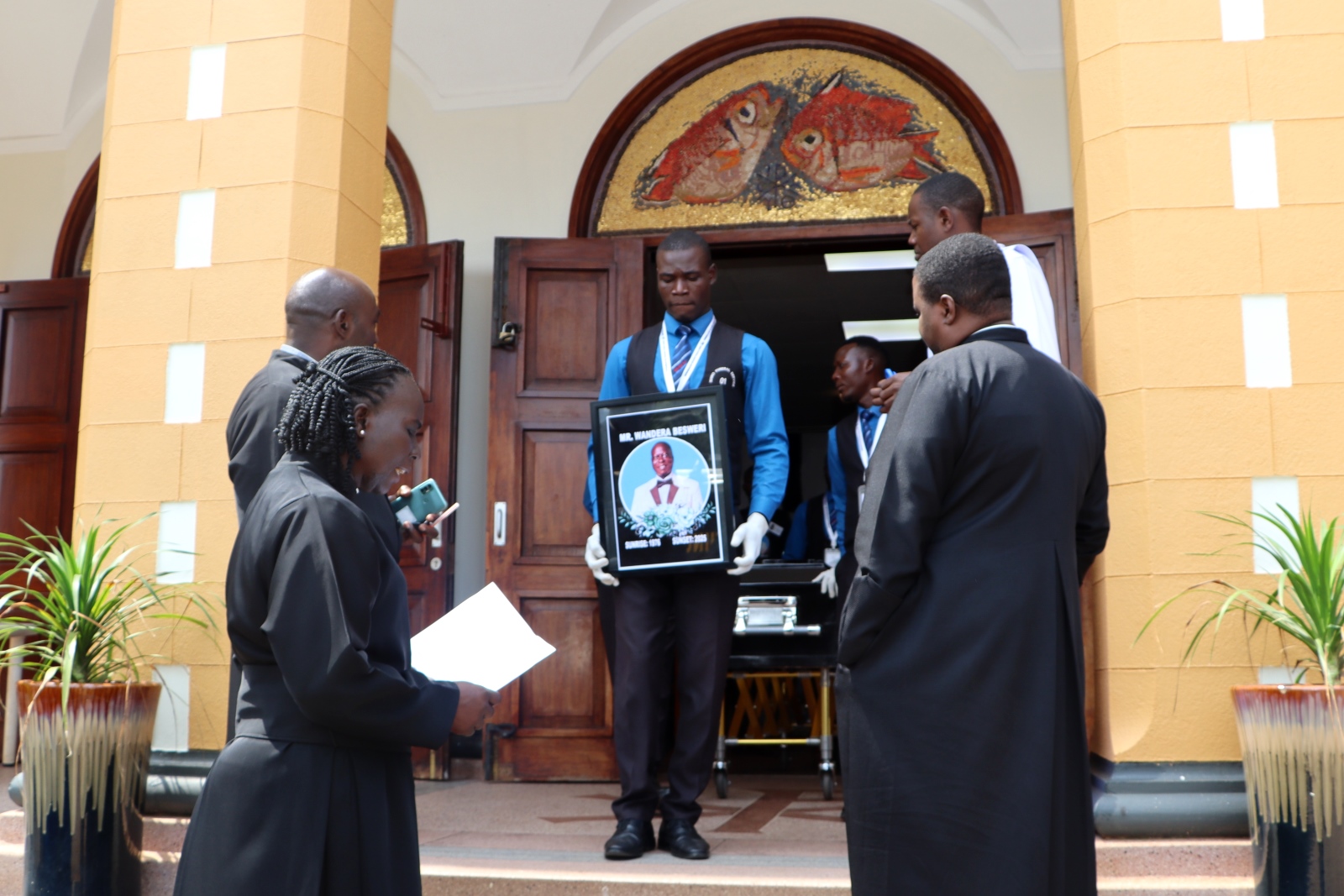 Pallbearers lead Mr. Besweri Wandera's casket out of St. Francis Chapel after the service. Funeral Service in honour Mr. Besweri Wandera, Assistant Lecturer, Department of Sports Science, College of Natural Sciences (CoNAS), 24th July 2025, St. Francis Chapel, Makerere University, Kampala Uganda, East Africa.