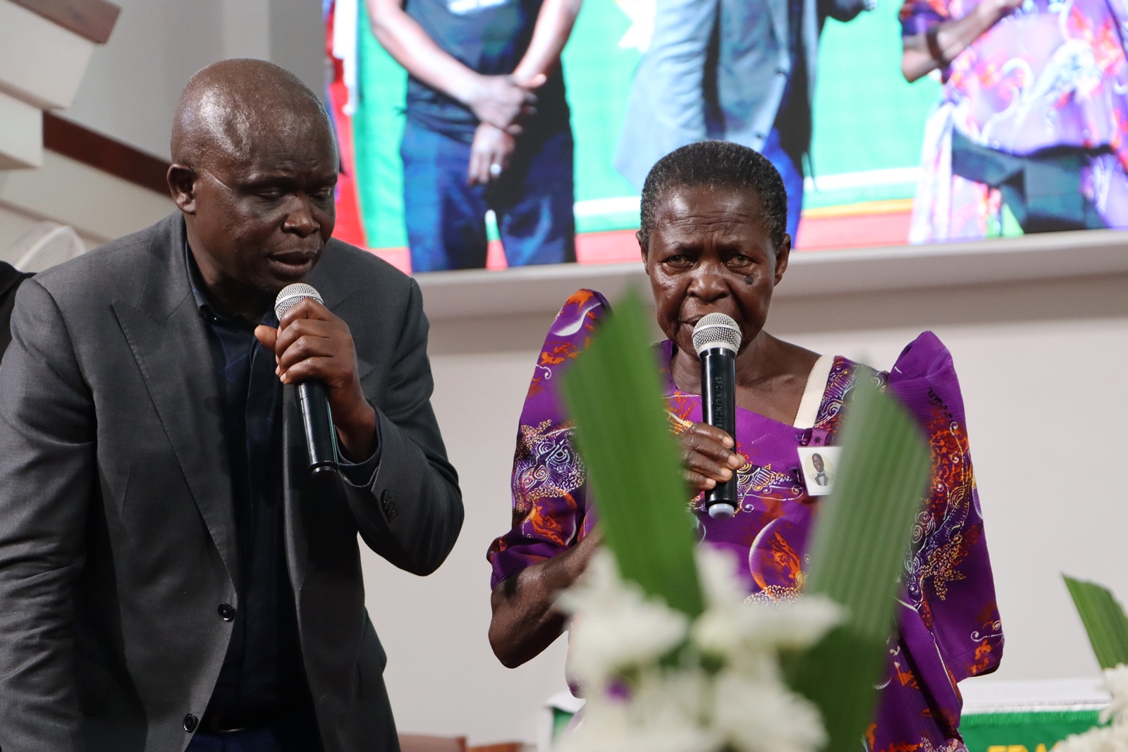 Mr. Wandera's Mother pays her respects as Mr. Isaac Egesa Obuli (Left) translates. Funeral Service in honour Mr. Besweri Wandera, Assistant Lecturer, Department of Sports Science, College of Natural Sciences (CoNAS), 24th July 2025, St. Francis Chapel, Makerere University, Kampala Uganda, East Africa.