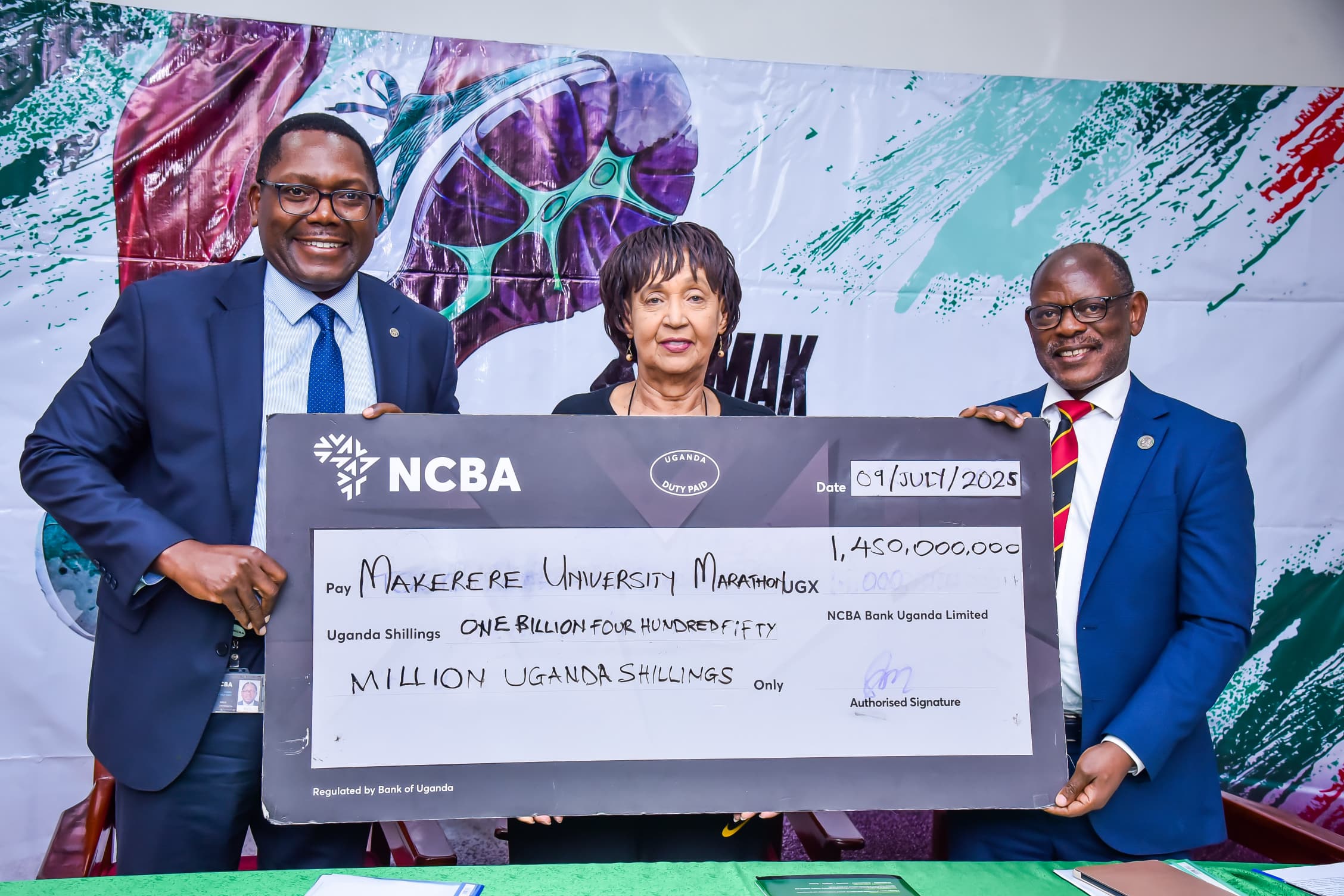Left to Right: NCBA Bank CEO-Mr. Mark Muyobo, MakEF Board Chairperson-Dr. Maggie Kigozi and the Vice Chancellor-Prof. Barnabas Nawangwe hold the dummy cheque unveiling the UGX 1.45 billion sponsorship for the Makerere Marathon for the next five years. Makerere University Endowment Fund (MakEF)’s flagship initiative – the Makerere University Marathon unveiling of NCBA Bank Uganda as Platinum Sponsor with UGX 1.45 Billion over five years, 9th July 2025, Kampala, East Africa.