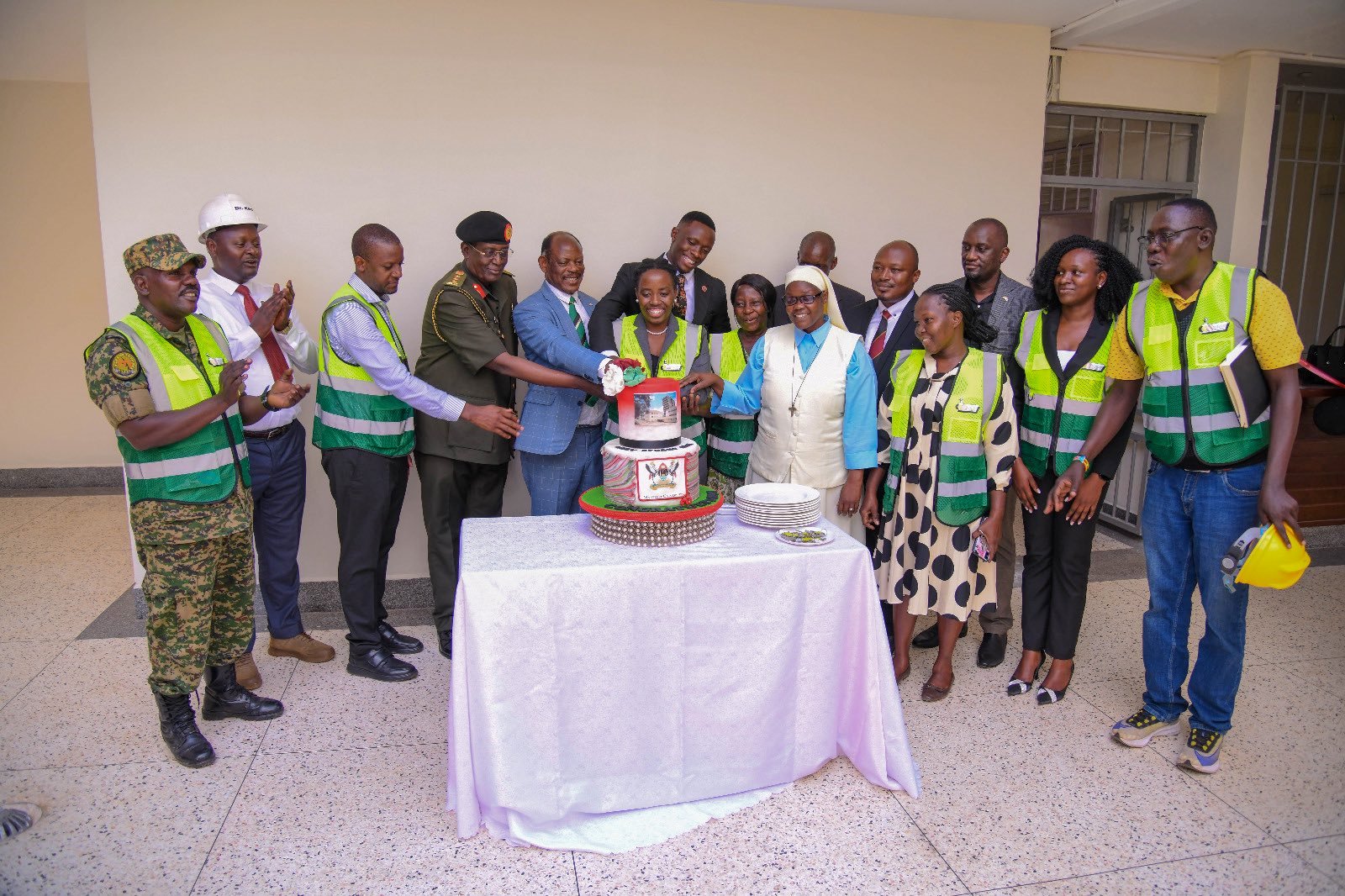 Mary Stuart Hall Chairlady-Ms. Anthea Ampaire (Centre) is joined by officials to cut cake in commemoration of the official handover. The National Enterprise Corporation (NEC) hands over fully refurbished Mary Stuart Hall. The renovation, which cost UGX 10.5 billion, began on 26th July 2024 and was completed exactly a year later, on 25th July 2025. Makerere University, Kampala Uganda, East Africa.