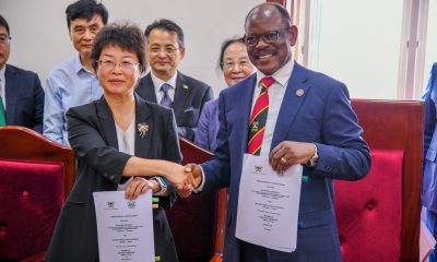 Prof. Barnabas Nawangwe (Right) and Prof. Zhu Yan (Left) shake hands as they display the signed MoU on 28th July 2025. Vice Chancellor, Prof. Barnabas Nawangwe signs MoU with Nanjing Agricultural University (NAU), China delegation led by Hon. Vincent Bamulangaki Ssempijja in pursuit of collaborative academic and industry research with a focus on agricultural and environmental sciences, 28th July 2025, Makerere University, Kampala Uganda, East Africa.