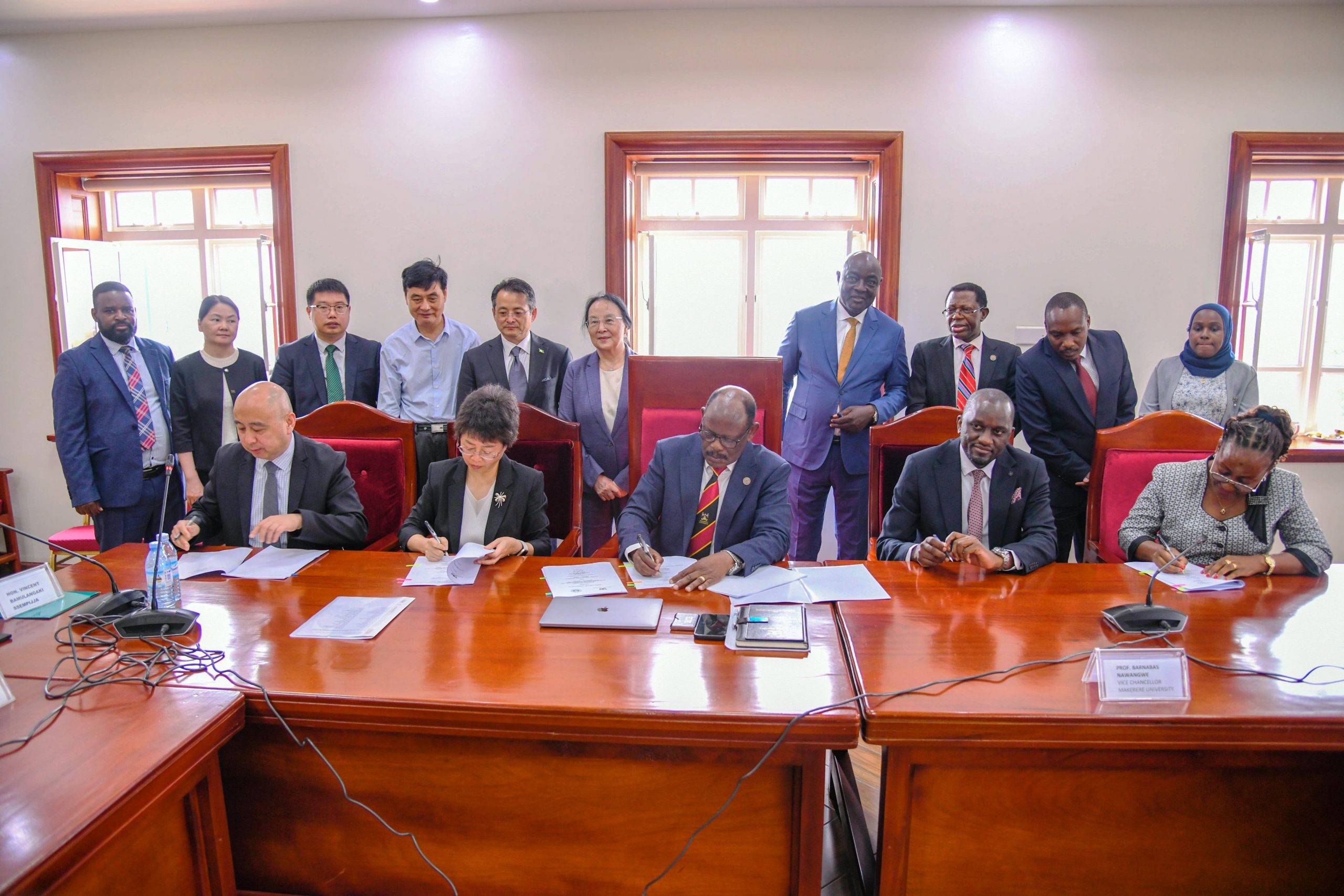 The MoU signing in progress. Vice Chancellor, Prof. Barnabas Nawangwe signs MoU with Nanjing Agricultural University (NAU), China delegation led by Hon. Vincent Bamulangaki Ssempijja in pursuit of collaborative academic and industry research with a focus on agricultural and environmental sciences, 28th July 2025, Makerere University, Kampala Uganda, East Africa.