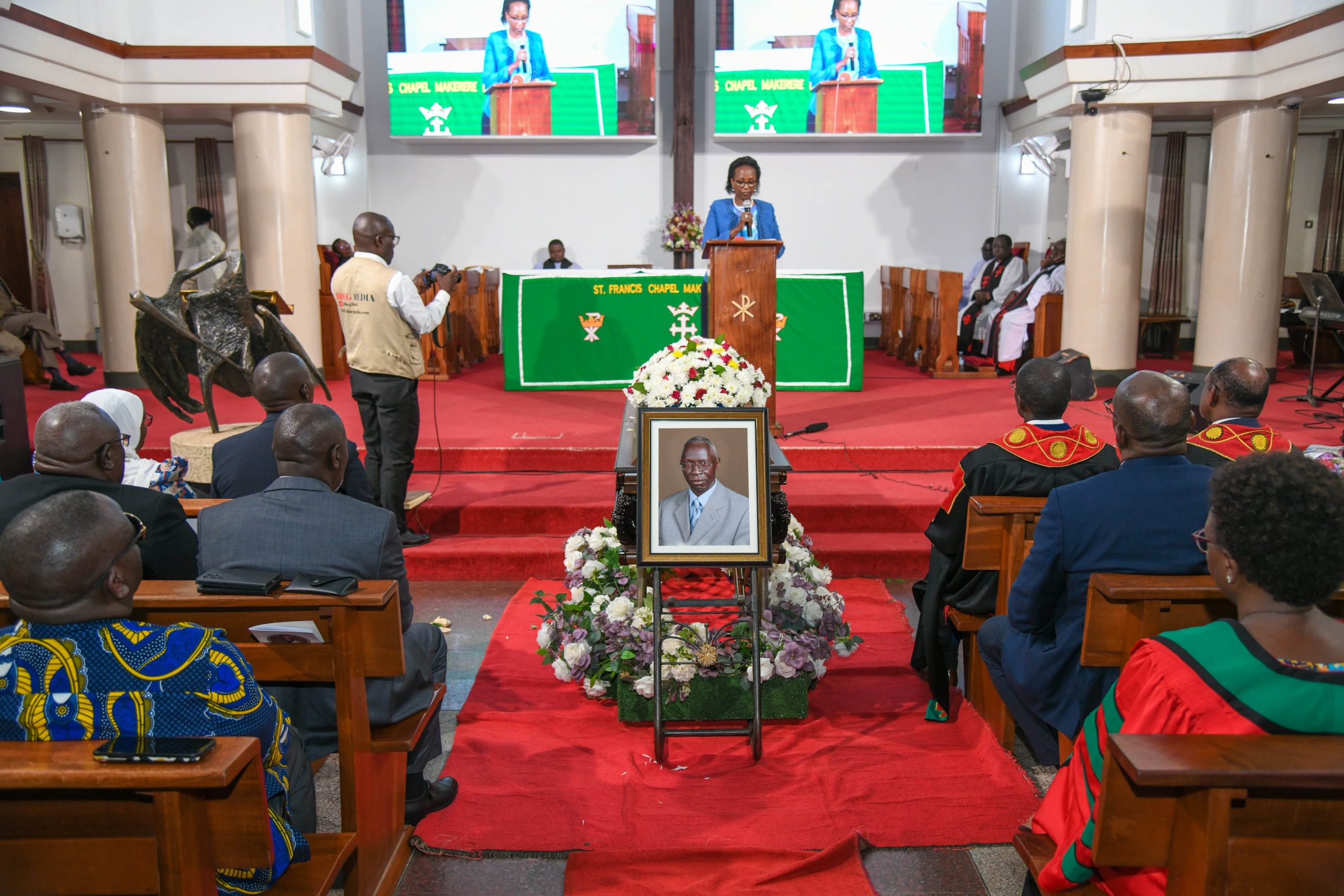 The Chairperson of Council, Mrs. Lorna Magara reads her condolence message as Professor Livingstone Sserwadda Luboobi's casket lies in St. Francis Chapel on 18th July 2025. Funeral service in honour of Professor Livingstone Sserwadda Luboobi, 18th July 2025, St. Francis Chapel, Makerere University, Kampala Uganda, East Africa.