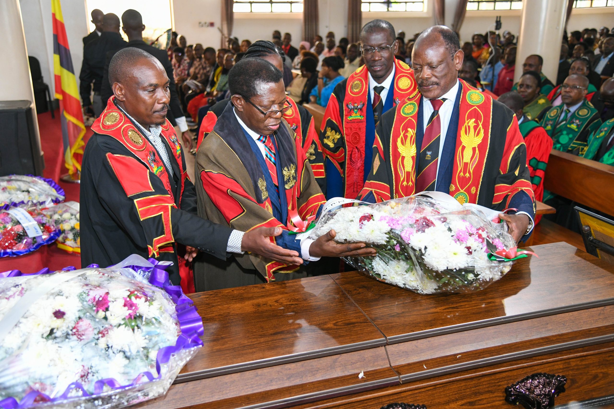 Prof. Barnabas Nawangwe (Right) joined by Left to Right: Prof. Winston Tumps Ireeta, Prof. Buyinza Mukadasi, Prof. Helen Nambalirwa Nkabala (Rear), and Prof. Frank N. Mwiine lays a wreath on Prof. Luboobi's casket. Funeral service in honour of Professor Livingstone Sserwadda Luboobi, 18th July 2025, St. Francis Chapel, Makerere University, Kampala Uganda, East Africa.