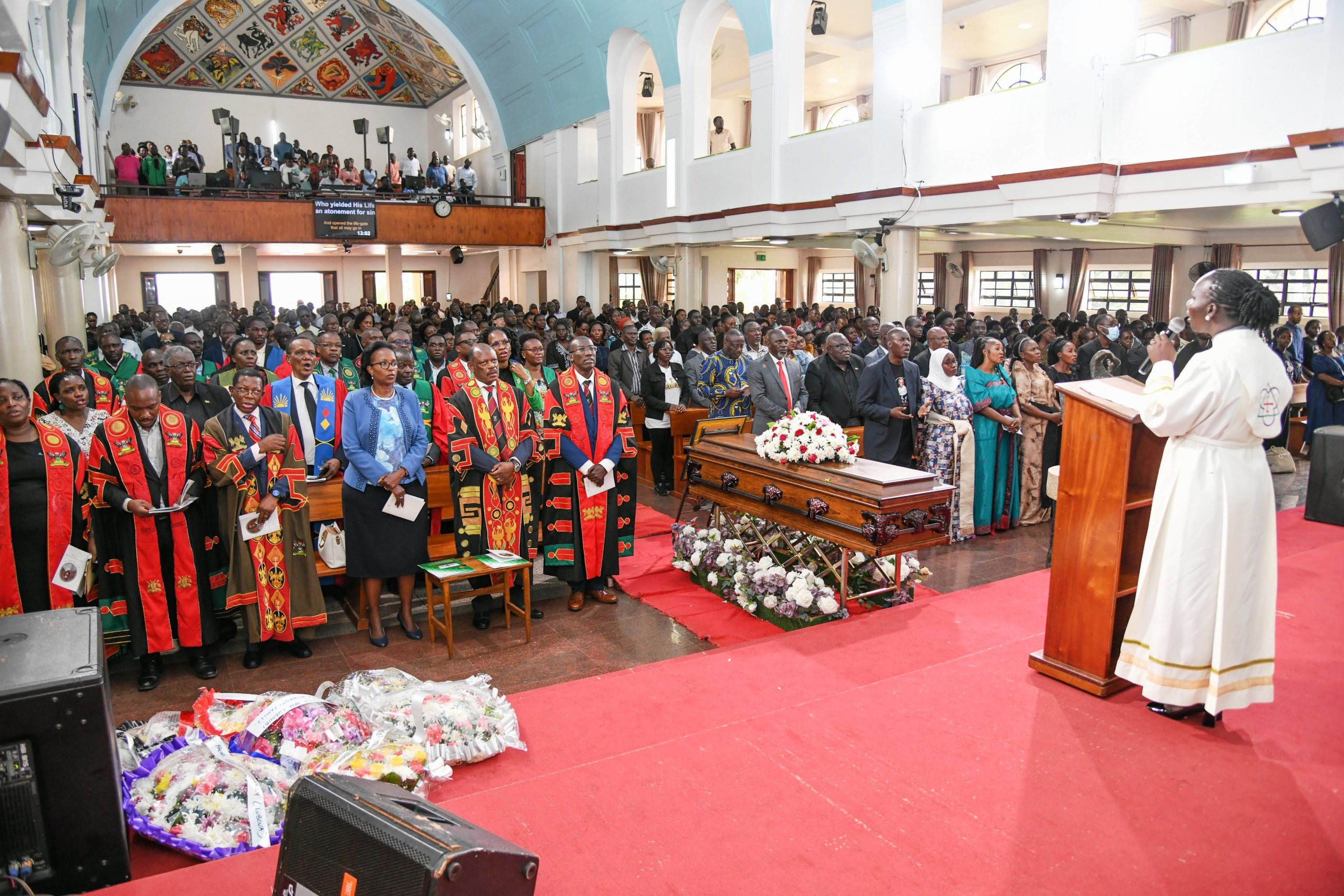 Rev. Scovia Kumakech (Right), University Leadership, Family and Friends join in song during Prof. Livingstone Luboobi's emotional send-off on 18th July 2025. Funeral service in honour of Professor Livingstone Sserwadda Luboobi, 18th July 2025, St. Francis Chapel, Makerere University, Kampala Uganda, East Africa.