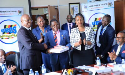 Dr. Chris Mukiza (L) hands over the donation to Prof. Buyinza Mukadasi (2nd L) as UBOS Board Director Dr. Allen Kabagenyi and other officials witness on 30th June 2025. Makerere University receiving 700 digital tablets from the Uganda Bureau of Statistics (UBOS), aimed at enhancing statistical research, teaching, and data-driven decision-making across the institution, 30th June 2025, Kampala Uganda, East Africa.
