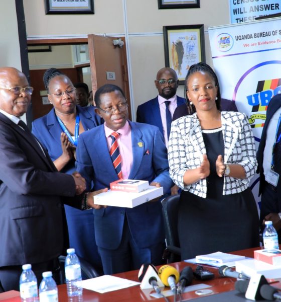Dr. Chris Mukiza (L) hands over the donation to Prof. Buyinza Mukadasi (2nd L) as UBOS Board Director Dr. Allen Kabagenyi and other officials witness on 30th June 2025. Makerere University receiving 700 digital tablets from the Uganda Bureau of Statistics (UBOS), aimed at enhancing statistical research, teaching, and data-driven decision-making across the institution, 30th June 2025, Kampala Uganda, East Africa.