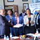 Dr. Chris Mukiza (L) hands over the donation to Prof. Buyinza Mukadasi (2nd L) as UBOS Board Director Dr. Allen Kabagenyi and other officials witness on 30th June 2025. Makerere University receiving 700 digital tablets from the Uganda Bureau of Statistics (UBOS), aimed at enhancing statistical research, teaching, and data-driven decision-making across the institution, 30th June 2025, Kampala Uganda, East Africa.