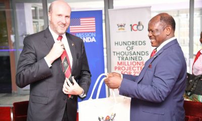 Prof. Barnabas Nawangwe, Vice Chancellor of Makerere University, presents a gift bag to U.S. Ambassador William W. Popp during his visit to the University
